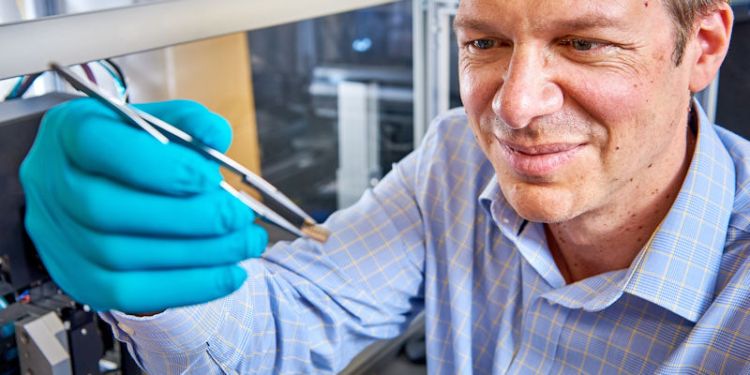 Christoph holding bioelectronics chip