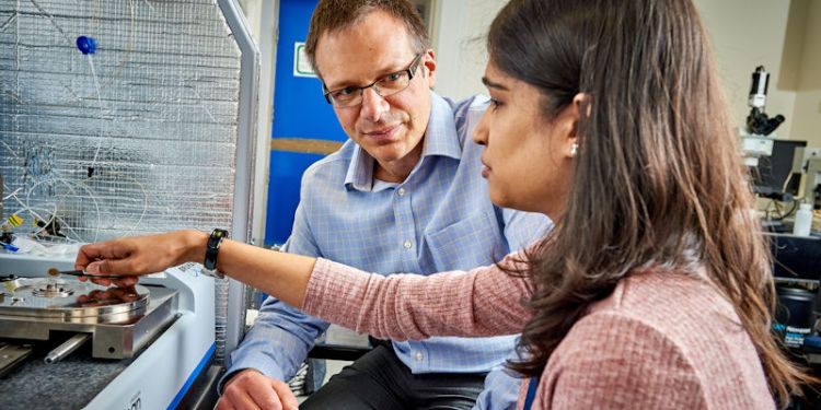 Professor Christoph Walti supervising a postgraduate researcher using an Atomic Force Microscope