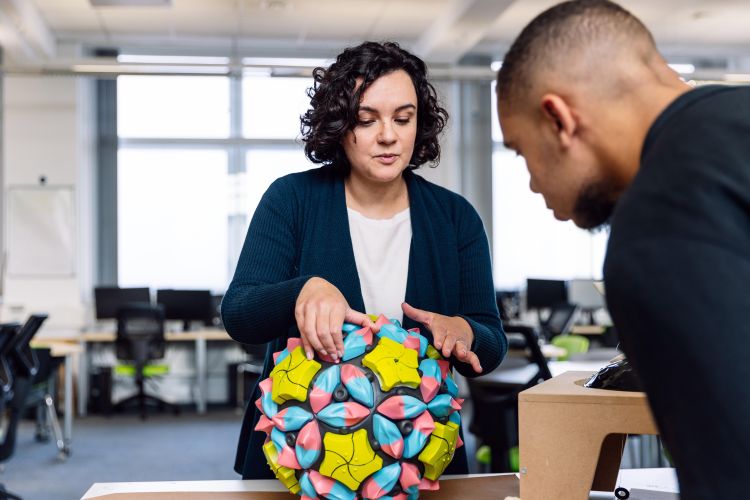 Briony Thomas presenting a model to a university visitor