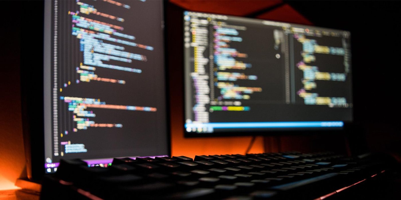 Software code on a computer screen in a dark room
