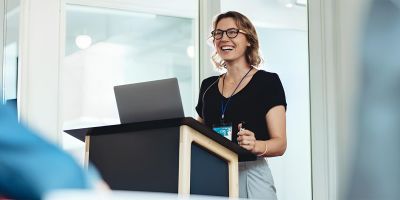 A woman presents behind a podium permissions hannah jackson lida 2