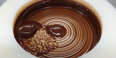A drop of molten chocolate ready to be inspected under a microscope
