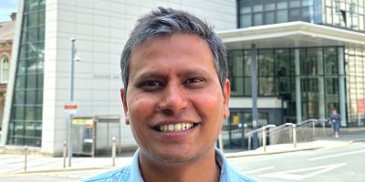 A headshot of Dr Sharib Ali, standing in front of the Ziff building