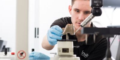 A scientist working on a polymer knee joint in a lab