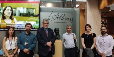 Professor Paul Monks and others standing for a photo in the Bragg Building.