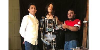 students Salah Al Abd and ziad Abass with Ai-Da
