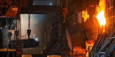 Interior of a steel refinery showing the entrance to a working furnace.