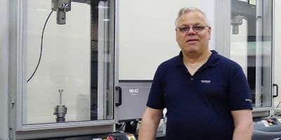 Tony Wiese standing next to a piece of technology at the University of Leeds.