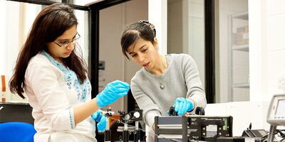 A student and academic in a lab