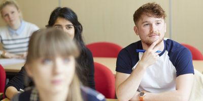 Prospective maths students listen intently during a mathematics application visit day