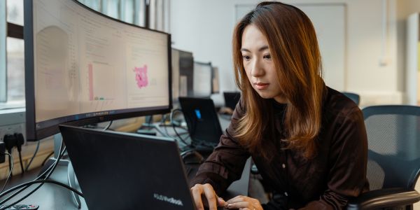 Female student doing data analysis on a laptop