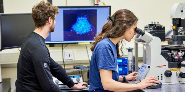 Two PGR students in a lab at the University of Leeds.
