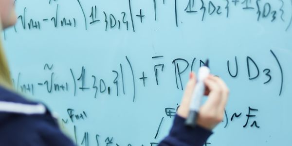 Student writing on a whiteboard