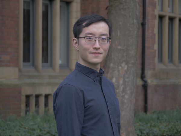 Muyou Li standing outside the Great Hall on campus