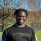 Jonathan Sisa Khabusi wearing a jumper, standing in front of a lake at roundhay park
