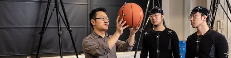 Dr He Wang and two students in a motion capture laboratory