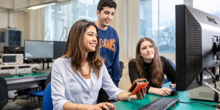 a group of students working in the electronics lab