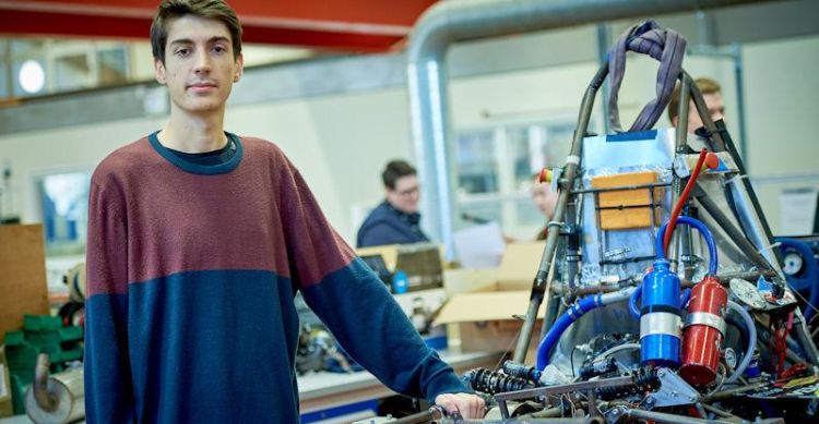 Roman Porazinski pictured with his team's Leeds Gryphon Racing car