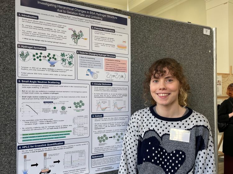 Female student presenting a poster of her research